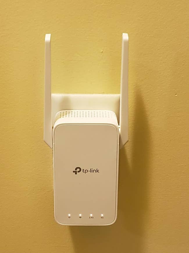 TP-Link Wi-Fi extender mounted on a wall