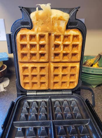 reviewers vertical waffle maker with waffle in it