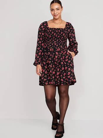 Model in long sleeve square neck midi dress with red rose detail 