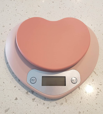 A light pink heart-shaped digital scale 