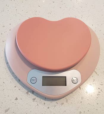 A light pink heart-shaped digital scale 