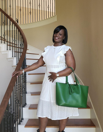 reviewer wearing the white dress