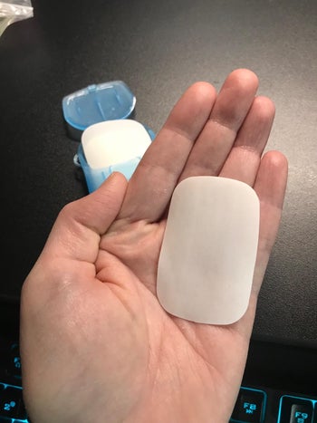 reviewer holding the soap sheet in their palm