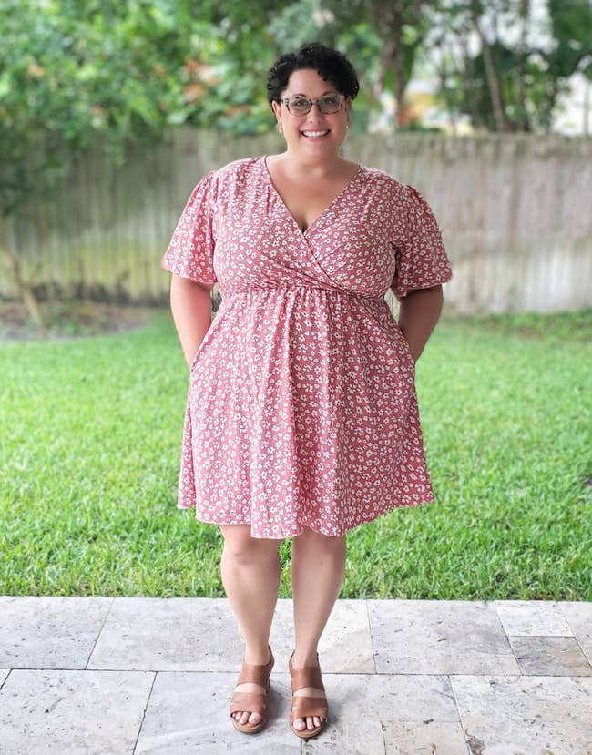 reviewer wearing the floral wrap dress
