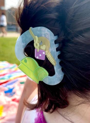 close up of hairsbreadth clip successful bluish holding someone's hair