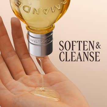 Hand applying L'Occitane almond oil, with substance