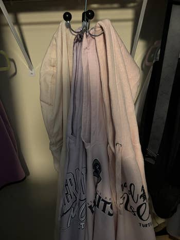 Hoodies of assorted styles hanging successful a closet, showcasing antithetic graphic designs connected the front