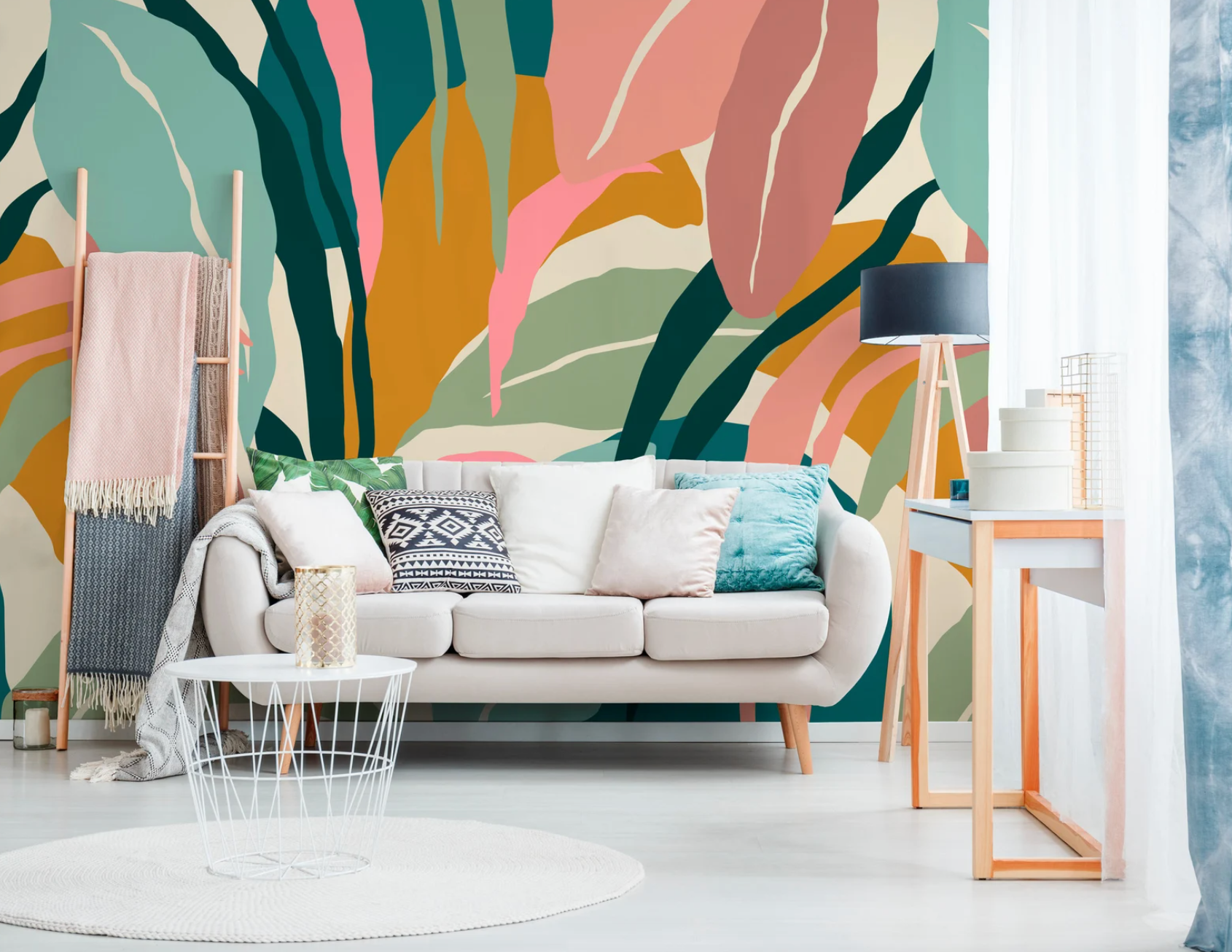 tropical leaf print pink, yellow, green, and navy blue peel-and-stick wallpaper behind white couch
