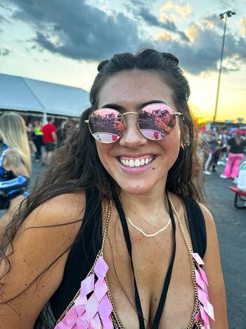 reviewer wearing round pink sunglasses
