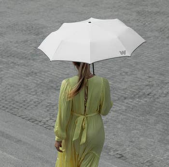 model using the white weatherman umbrella