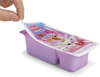 A model peeling back the packaging of the toy