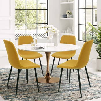 Dining country   with a circular  table, 4  modern   chairs, and a decorative centerpiece, acceptable   connected  a patterned rug adjacent   ample  windows