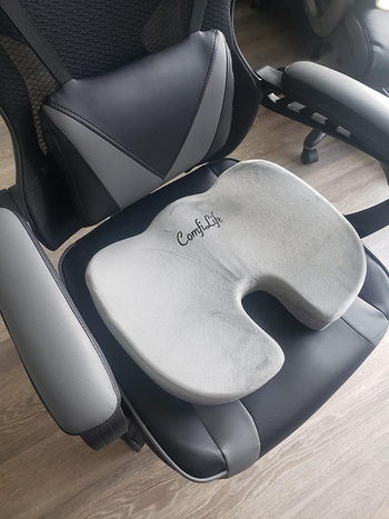 reviewer photo of the gray cushion on a black office chair