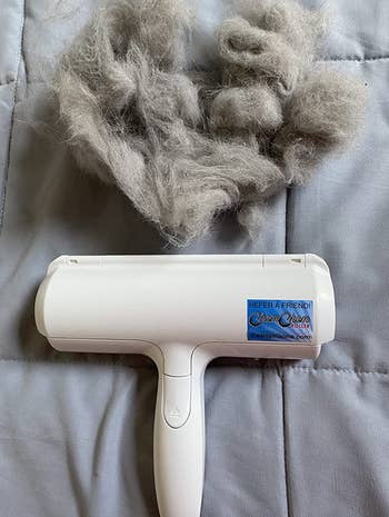 reviewer photo of the pet hair roller next to a clump of pet fur