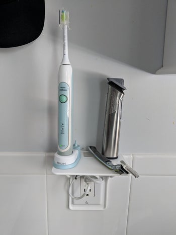 a reviewer uses the shelf for a toothbrush and razor