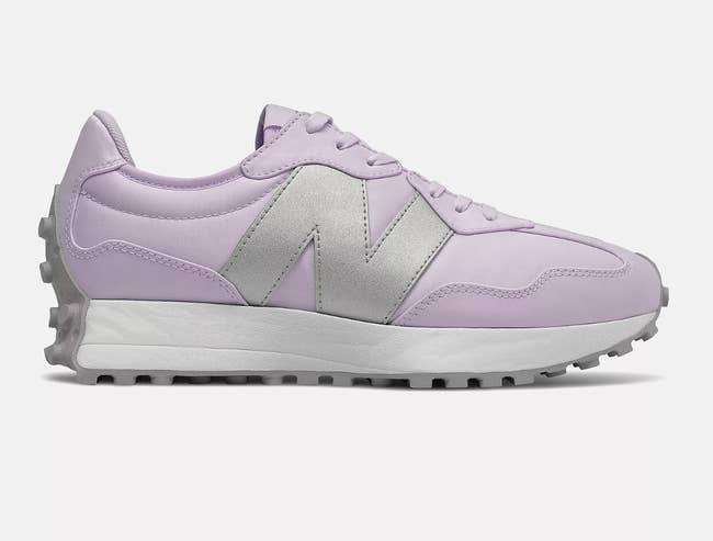 the tennis shoes in lilac with silver N on the side and white sole