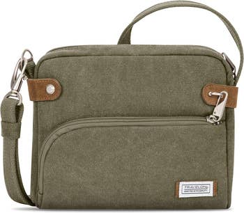 Olive green travel bag with multiple compartments and an adjustable strap