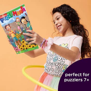 a child reading one of the puzzle books