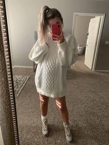 reviewer mirror selfie wearing white sweater dress