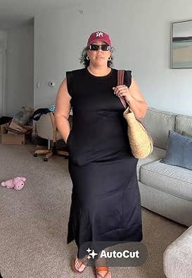 Person wearing a sleeveless achromatic formal and cap, holding a straw bag, lasting successful a surviving room