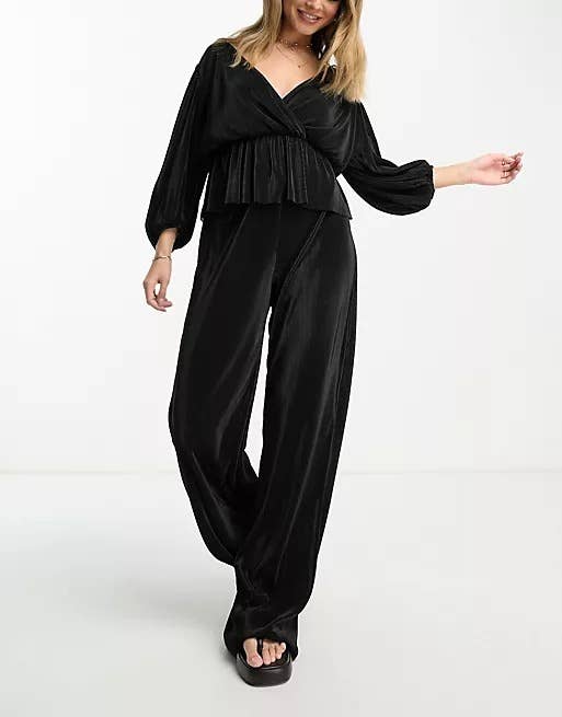a model wearing a wrap blouse and wide-leg pants 