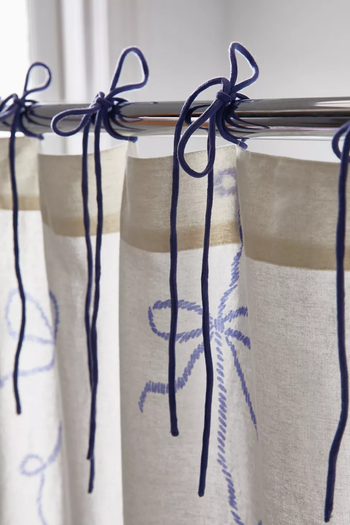 dark blue bows on the top of the shower curtain