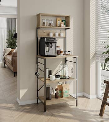 the baker's rack in light oak with coffee tools and appliances on it for a makeshift coffee bar