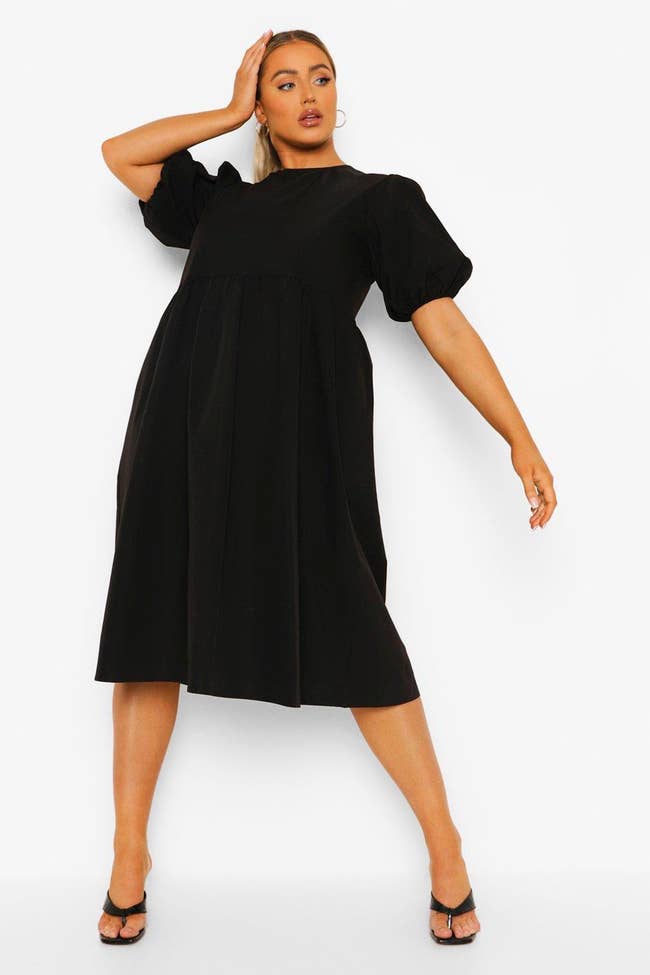 plus size model in midi dress with elbow-length bell sleeves 