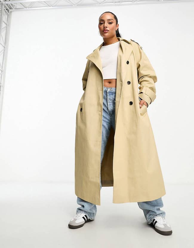 A model in the sand colored classic trench style coat