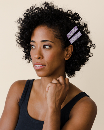 model wearing two purple MAMA barrettes in their hair