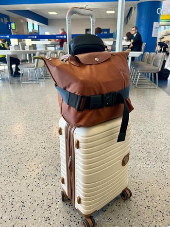 reviewers bag on their suitcase secured using a Cincha belt