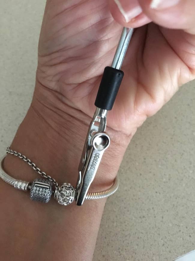 a reviewer using the tool to fasten a bracelet