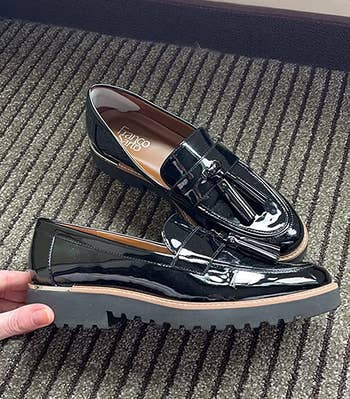 the black loafers, with a hand showing a side view with the thick lug sole