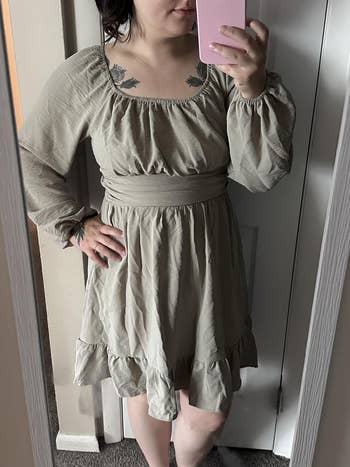 Person successful a light, flowy formal takes a reflector selfie, showcasing a casual, comfy benignant suitable for shopping