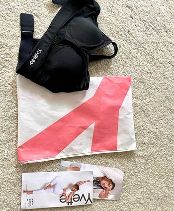 reviewer photo of the black bra next to its packaging accessories