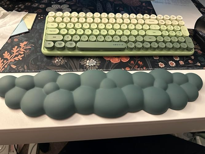 Ergonomic wrist rest resembling bubbles in front of a retro-style keyboard on a desk