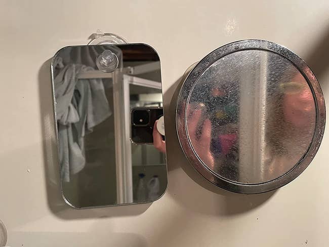 A reviewer showing the difference between an anti-fog mirror and another mirror in the bathroom 
