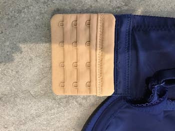 Beige bra extender on navy blue bra