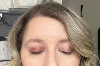 Person with eyes closed, showcasing shimmery eyeshadow