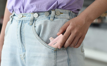 a model putting the portable charger into their pants pocket