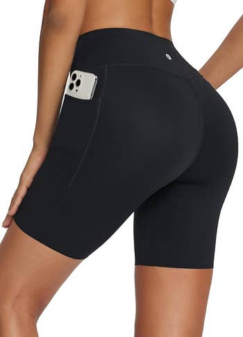 Person wearing black bike shorts with a smartphone in the pocket
