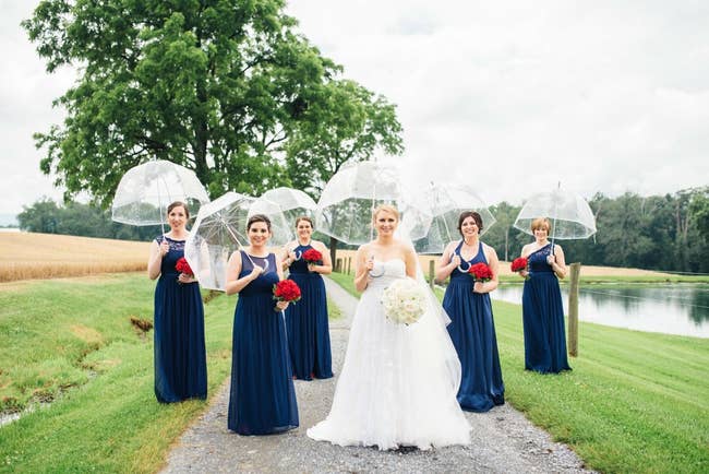 a reviewer and their bridal party holding clear bubble umbrellas