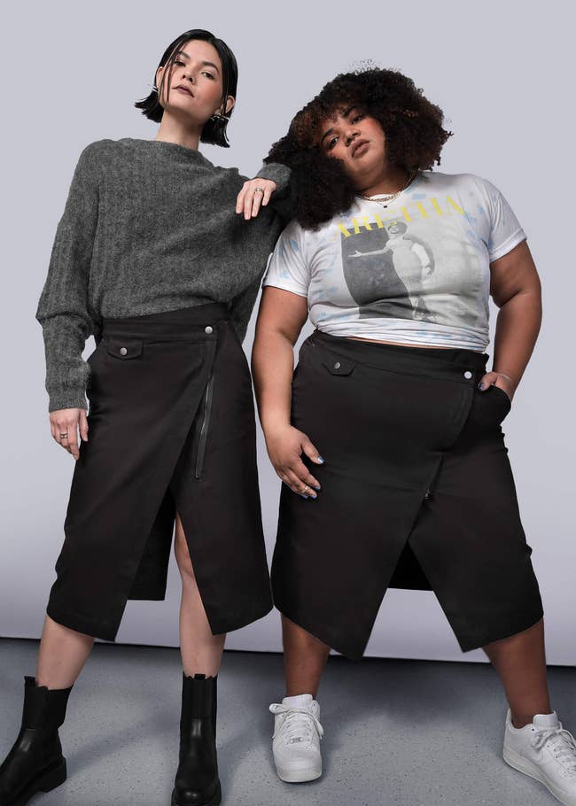 Two models wearing stylish achromatic skirts and casual tops, posing confidently for a manner shoot