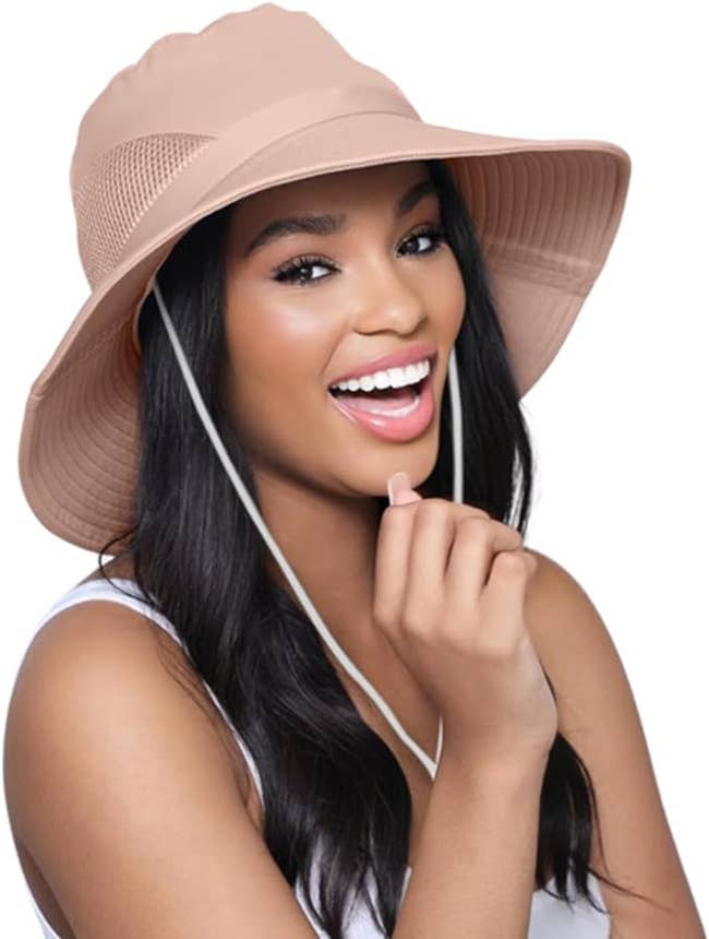 a model wearing the hat in light pink 