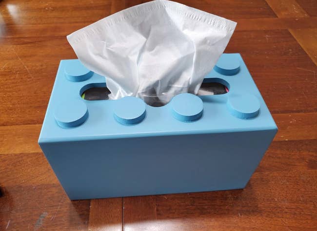 Tissue container  shaped similar  a gathering  artifact  connected  a woody  table