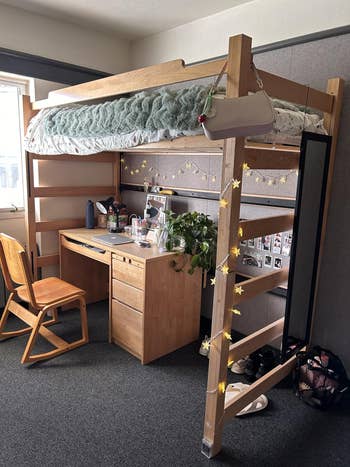Loft furniture  implicit    a neatly organized survey  table  with assorted  items, a chair, and potted plant. String lights adhd  decorative touches