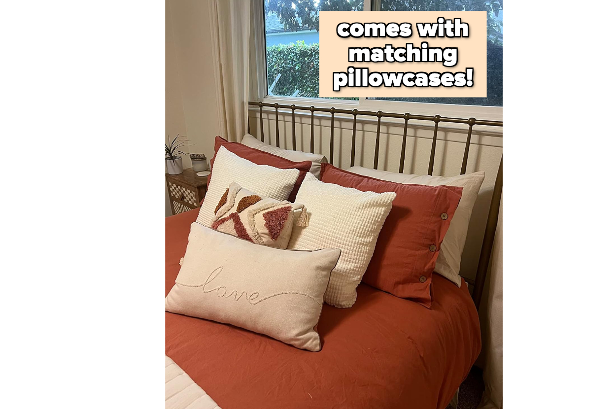 Bed with rust-colored bedding and assorted pillows; includes matching pillowcases