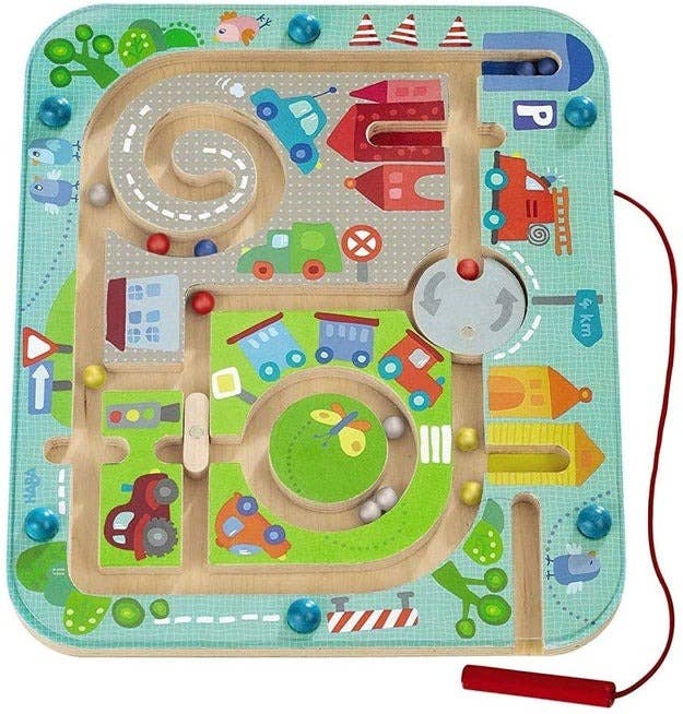 A toy that has kids move magnetic marbles through a maze with a stylus
