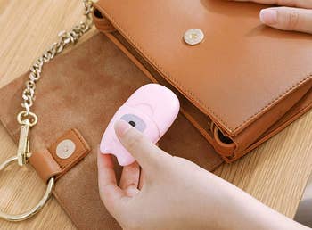 model putting paper soap set into a purse