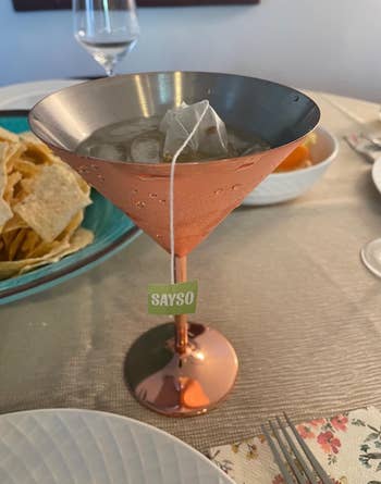 Cocktail successful  a metallic  solid  with a SAYSO beverage  bag, acceptable   connected  a eating  array  with chips and plates nearby
